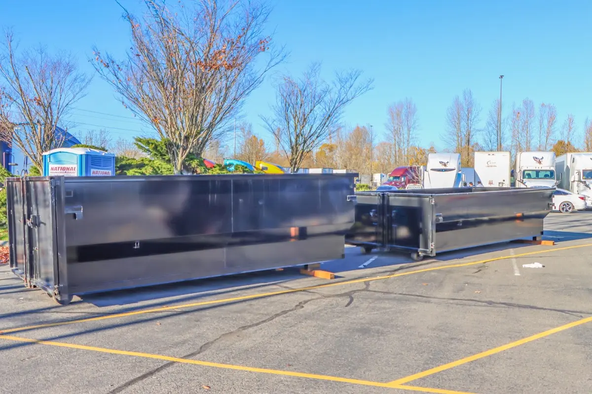 Professional dumpster rental service with roll-off container on residential driveway in Santa Barbara